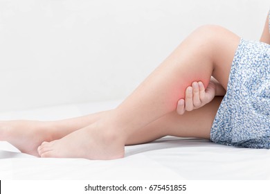 Leg Pain Or Calf Muscle In A Girl On Bed, Healthy Concept