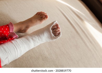 Leg In Plaster Of A Teenage Girl On A Sofa After An Accidental Fall With An Ankle Fracture