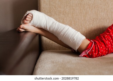 Leg In Plaster Of A Teenage Girl On A Sofa After An Accidental Fall With An Ankle Fracture