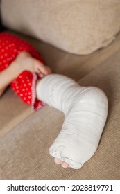 Leg In Plaster Of A Teenage Girl On A Sofa After An Accidental Fall With An Ankle Fracture