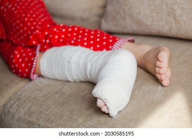 Leg In Plaster Of A Teenage Girl On A Sofa After An Accidental Fall With An Ankle Fracture