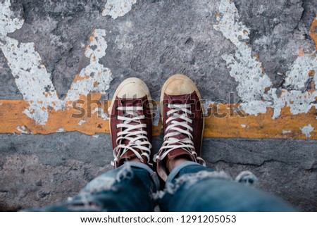 leg woman wear brown sneakers canvas shoes and jean walking.with copy space for text.stylish and people in street urban fashion.accessories men and women foot wear concept.
