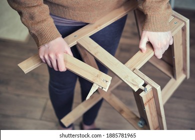 Leg Of The Wooden Chair Broken At The Base. Stepladder Broken In Woman Hands. Problems With Safety Of Work At Home