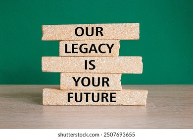 Legacy and future symbol. Concept words Our legacy is your future on brick blocks. Beautiful wooden table green background. Business legacy and future concept. Copy space. - Powered by Shutterstock