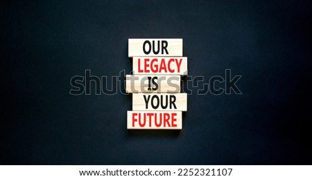 Legacy and future symbol. Concept words Our legacy is your future on wooden blocks. Beautiful black table black background. Business legacy and future concept. Copy space.