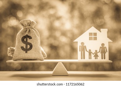 Legacy / inheritance or death tax concept : US dollar bag, a house and family members e.g father, mother, son, daughter on a balance scale, depicts a tax paid by person who inherits money or property. - Shutterstock ID 1172165062