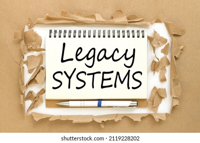 Legacy Systems. Business concept open notepad with text on torn paper background