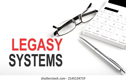 LEGACY SYSTEMS Concept. Calculator,pen and glasses on white background