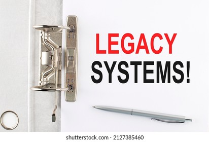 LEGACY SYSTEMS text on paper folder with pen. Business concept