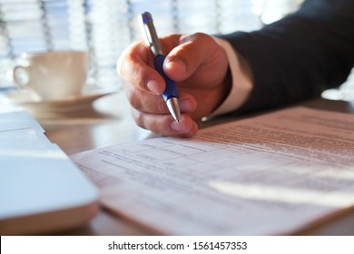 legal advice from lawyer or notary, compliance, verification of contract conditions,  close up of hand with pen and document - Shutterstock ID 1561457353