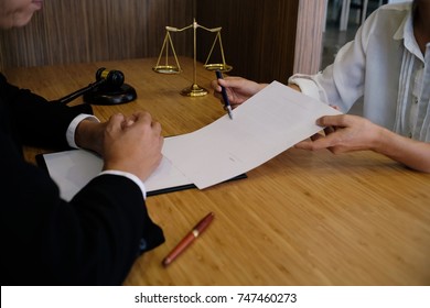 Legal Counsel Presents To The Client A Signed Contract With Gavel And Legal Law. Justice And Lawyer Concept