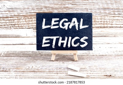 LEGAL ETHICS text on Miniature chalkboard on wooden background - Shutterstock ID 2187817853