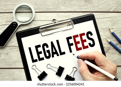 legal Fees. wooden background. text on white paper. black folder with clip. - Shutterstock ID 2256004241