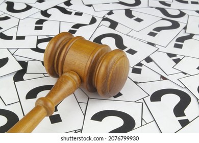 Legal Help Concept. Judge Gavel On Question Marks Background.