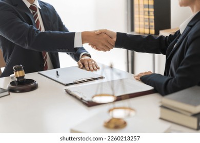 Legal and justice concept, Businessman shaking hands with female lawyer after agreement contract. - Shutterstock ID 2260213257