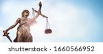 Legal and law concept statue of Lady Justice with scales of justice and sky background