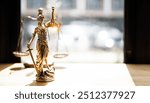 Legal and law concept. Statue of Lady Justice with scales of justice and wooden judge gavel on wooden table. Panoramic image statue of lady justice.	