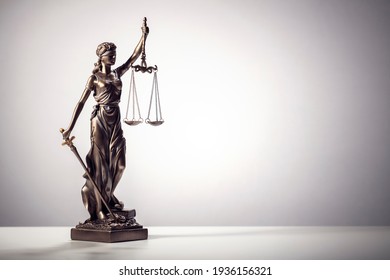 Legal law concept statue of Lady Justice with scales of justice background