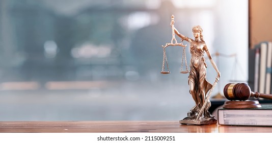 Legal and law concept. Statue of Lady Justice with scales of justice and wooden judge gavel on wooden table. Panoramic image statue of lady justice. - Shutterstock ID 2115009251
