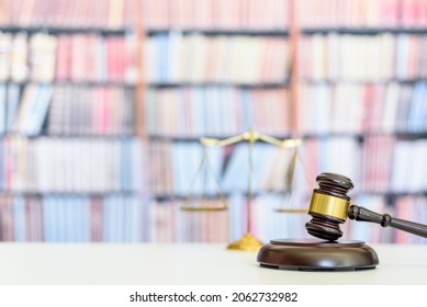 Legal Office Of Lawyers, Justice And Law Concept : Judge Gavel Or A Hammer And A Base Used By A Judge Person On A Desk In A Courtroom With Blurred Weight Scale Of Justice, Bookshelf Background Behind