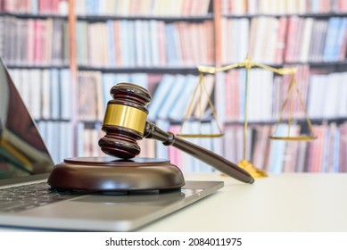 Legal office of lawyers, justice and law concept : Judge gavel or a hammer and a base used by a judge person on a desk in a courtroom with blurred weight scale of justice. - Shutterstock ID 2084011975