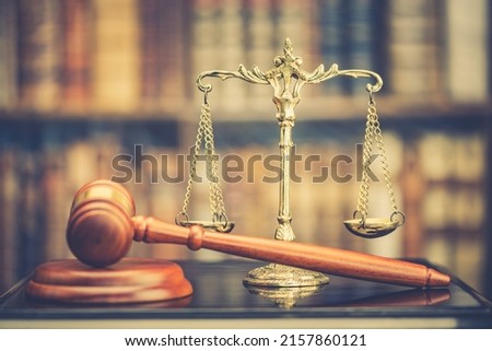 Legal office of lawyers, justice and law concept : Retro balance scale of justice on a desk in a courtroom, depicting giving fair and objective consideration to all evidence, without showing bias.