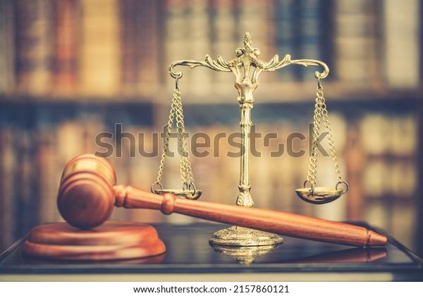 Legal office of lawyers, justice and law concept :\
Retro balance scale of justice on a desk in a courtroom, depicting\
giving fair and objective consideration to all evidence, without\
showing bias.