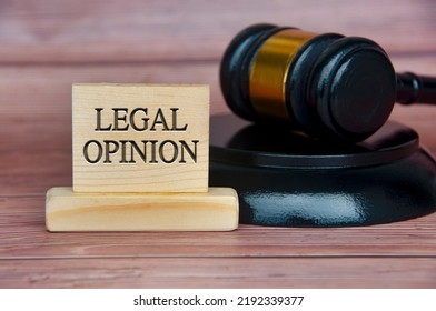 Legal Opinion Text Engraved On Wooden Block With Gavel Background. Legal And Law Concept.