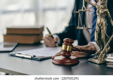 Legal services concepts at the Computer Labor Law Advising Office. lawyer working at the desk Hammer and scales on lawyer's table for justice