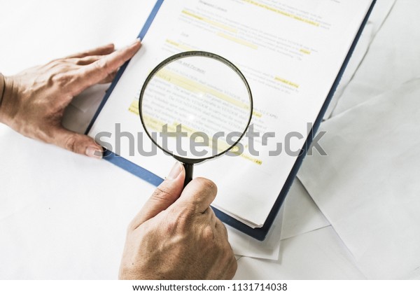 Legal team checking the fine
print on business contract to analyze terms and conditions and
sign.
