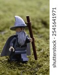 Lego gandalf on a green moss field in nature