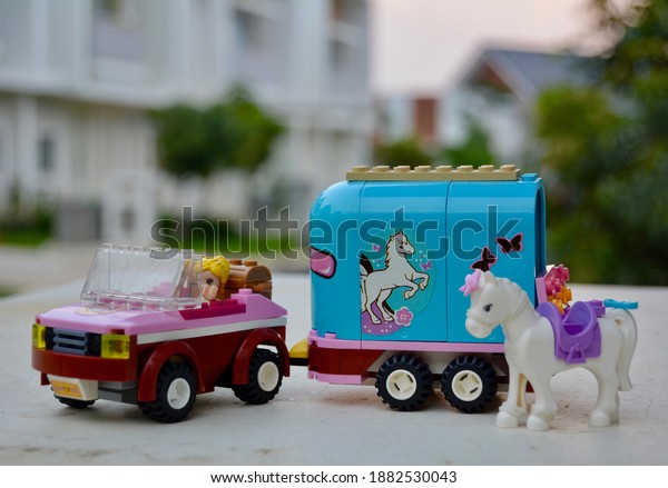 Lego mini figure on car\
with horse and caravan. Bandung, West Java Indonesia - November 29,\
2019.