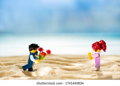 Lego Minifigures On Sandy Beach. Two Adults Wearing Protective Mask Have Date. Social Distancing Concept. Soft Focus. Lviv, 
Ukraine - May, 23, 2020