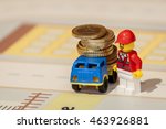 Lego toy man with a truck full of euro coins, financial illustration (news, money, abstract, cash, finance, salary, savings, bank, loan, mortgage, benefit, dividend, interest)