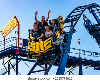 LEGOLAND, GERMANY - AUGUST 24th, 2019: Family Having Fun Riding A Rollercoaster In Amusement Park