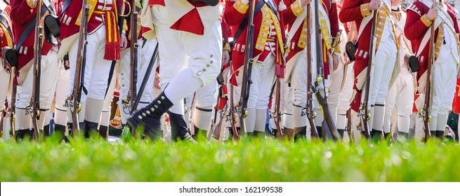 Legs Of British Soldiers Of American Revolutionary War On Green Battlefield In Lexington, MA