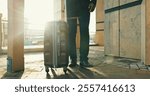 Legs, business or travel with suitcase outdoor in city for journey, corporate trip or immigration flight at airport. Luggage, shoes or professional person walk to building, hotel or commute in street