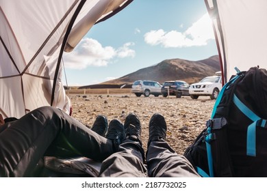 Legs Of Couple Traveler Relaxing Inside A Tent In Wilderness On Campground In Summer At Iceland
