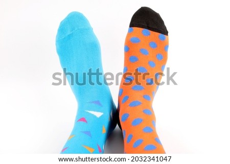 Legs with different a pair of mismatched socks on white background. World Down syndrome day background. Down syndrome awareness concept. Copy space. 