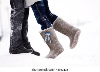 legs embracing couples standing on the snow snowy winter in the middle of the field - Powered by Shutterstock