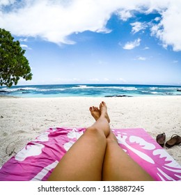 Legs With Fake Spray Tan On Sun Lounger On Tropical Beach With Pink Towel At Lefaga, Upolu Island, Western Samoa, South Pacific