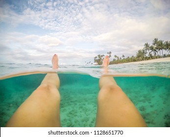 Legs And Feet POV - Split Point Of View Of Woman Floating In Clear Sea At A Beach At Matautu, Lefaga, Upolu Island, Western Samoa, South Pacific