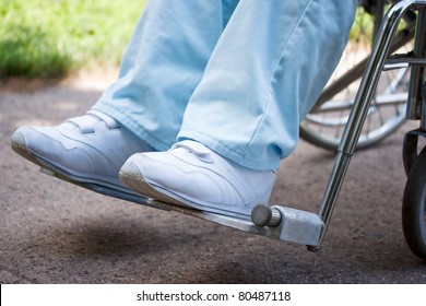 Legs and feet of woman sitting in wheelchair