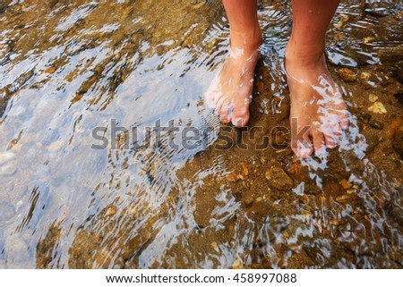 legs foot in the water splashing