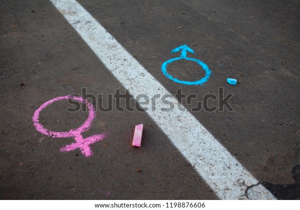 Legs with\
gender symbol on asphalt, gender\
concept