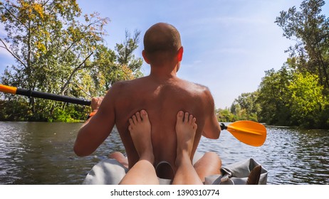 The Legs Of The Girl On The Back Rower Paddle. Vorskla River, Ukraine.