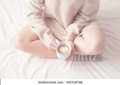 Legs Of Girl Warm Woolen Socks And A Cup Of Coffee Warming, Winter Morning At Home In Bed