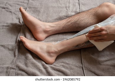 Legs Hair Removal For Men. Apply Hair Removal Cream To One Of The Legs.