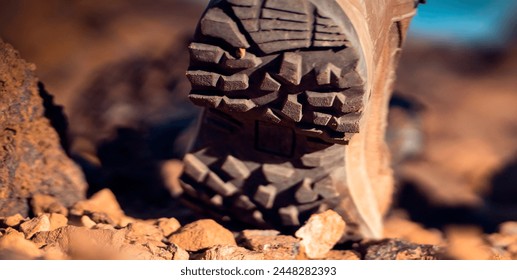 Legs in high hiking boots of coyote color with a textured sole close-up, a girl walks along a path in the mountains, rocky terrain in comfortable shoes for active pastime in a daytime. - Powered by Shutterstock