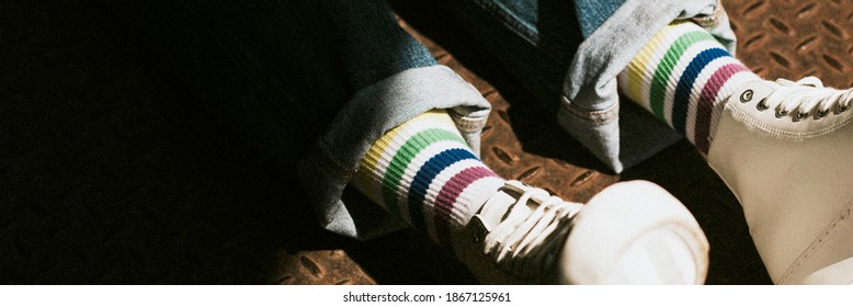 Legs In High Top White Sneakers On Jeans Model Banner